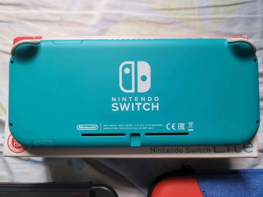 Turquoise Nintendo Switch Lite with accessories