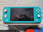 Turquoise Nintendo Switch Lite with accessories